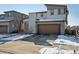 Two-story home showing its siding and garage with snow covered front lawn at 18012 E 107Th Ave, Commerce City, CO 80022