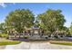 Charming coffee house exterior featuring a covered porch and surrounded by mature trees at 18012 E 107Th Ave, Commerce City, CO 80022