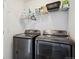 Laundry room with stainless steel washer and dryer units and shelving at 18012 E 107Th Ave, Commerce City, CO 80022