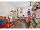 Charming playroom with hardwood floors, lots of toys, and storage shelves at 18012 E 107Th Ave, Commerce City, CO 80022