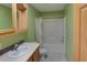 View of a bathroom with green walls, a shower-tub combination, a sink and vanity at 233 Cherokee Ct, Brighton, CO 80603