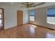 Bright bedroom with hardwood floors, large windows, ceiling fan and ample closet space at 233 Cherokee Ct, Brighton, CO 80603
