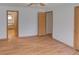 Spacious main bedroom with hardwood floors and easy access to en suite bathroom at 233 Cherokee Ct, Brighton, CO 80603