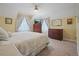 Cozy bedroom features a ceiling fan, neutral carpet, and natural light from the windows at 945 Niagara St, Denver, CO 80220