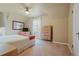 Comfortable bedroom featuring sloped ceilings, carpet, ceiling fan, and natural light at 945 Niagara St, Denver, CO 80220