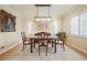 Formal dining room with a wooden table set on a patterned rug, lit by a modern pendant light fixture at 945 Niagara St, Denver, CO 80220