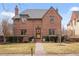 Charming brick two-story home with manicured lawn, slate roof and welcoming front entry at 945 Niagara St, Denver, CO 80220