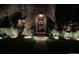 Well-lit home exterior with manicured bushes, plants and a stone walkway leading to the front door at 945 Niagara St, Denver, CO 80220