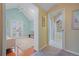 Hallway view into a bright living room with french doors and a full bathroom at 945 Niagara St, Denver, CO 80220