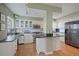 Modern kitchen featuring stainless steel appliances, island, and classic white cabinetry at 945 Niagara St, Denver, CO 80220