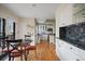 Open kitchen with white cabinetry and a dining area, creating a seamless blend of cooking and dining spaces at 945 Niagara St, Denver, CO 80220