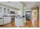 Well-lit kitchen featuring stainless steel appliances, island, and subway tile backsplash at 945 Niagara St, Denver, CO 80220