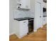 Small bar area with a beverage fridge and a tiled backsplash at 14075 Willow Wood Ct, Broomfield, CO 80020