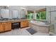 Bright bathroom featuring a soaking tub with jets, walk in shower and double sink vanity with natural light at 14075 Willow Wood Ct, Broomfield, CO 80020