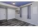 Bedroom features wood floors, blue accent wall, window with blinds, and closet at 14075 Willow Wood Ct, Broomfield, CO 80020