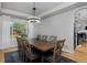 Dining area with a large wooden table, modern chandelier, and view of backyard at 14075 Willow Wood Ct, Broomfield, CO 80020