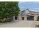 Beautiful two-story home with a large tree in the front yard and a three car garage at 14075 Willow Wood Ct, Broomfield, CO 80020