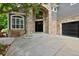 Inviting stone entrance with a black front door and an arched window above at 14075 Willow Wood Ct, Broomfield, CO 80020