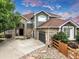 Charming front exterior with stone accents, three-car garage, and manicured landscaping in a great neighborhood at 14075 Willow Wood Ct, Broomfield, CO 80020