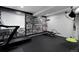 Basement gym with sleek black treadmill, weight bench and eye-catching typography wall art at 14075 Willow Wood Ct, Broomfield, CO 80020