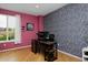 Bright office space featuring natural light, hardwood floors, and colorful accent wall at 14075 Willow Wood Ct, Broomfield, CO 80020