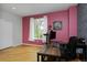 Bright office space featuring natural light, hardwood floors, and colorful accent wall at 14075 Willow Wood Ct, Broomfield, CO 80020
