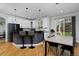 Eat-in kitchen with white cabinetry, dark countertops, stainless appliances and a breakfast bar at 14075 Willow Wood Ct, Broomfield, CO 80020