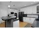 Spacious kitchen with white cabinets, black countertops, and a black refrigerator at 14075 Willow Wood Ct, Broomfield, CO 80020