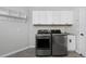 Well-equipped laundry room featuring modern washer/dryer and ample cabinet storage at 14075 Willow Wood Ct, Broomfield, CO 80020