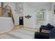 Open floor plan with hardwood floors, staircase, and a large window with sheer curtains at 14075 Willow Wood Ct, Broomfield, CO 80020