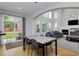 Open concept living room with dining table, fireplace, and sliding doors to patio at 14075 Willow Wood Ct, Broomfield, CO 80020