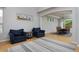 Bright living room with hardwood floors, blue chairs, and a view into the dining room at 14075 Willow Wood Ct, Broomfield, CO 80020