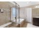 Luxurious bathroom featuring a soaking tub, glass shower, and tile flooring at 129 N Irvington St, Aurora, CO 80018