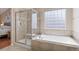 Bathroom with soaking tub, shower and tile surround at 129 N Irvington St, Aurora, CO 80018