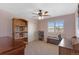Cozy bedroom with neutral carpet, ceiling fan and a window overlooking the front yard at 129 N Irvington St, Aurora, CO 80018