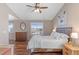 Light filled bedroom with wood floors, a ceiling fan, and a large window with views at 129 N Irvington St, Aurora, CO 80018