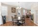 Dining area with views to living room and kitchen, featuring hardwood floors, and a modern chandelier at 129 N Irvington St, Aurora, CO 80018