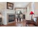 Open dining area features a fireplace, hardwood floors, natural light, and views to the living room at 129 N Irvington St, Aurora, CO 80018