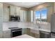 Well-equipped kitchen with stainless steel appliances and a farmhouse sink at 129 N Irvington St, Aurora, CO 80018