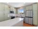 Bright kitchen featuring white quartz counters, stainless steel appliances, hardwood floors, and ample cabinet space at 129 N Irvington St, Aurora, CO 80018