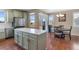 Open kitchen and dining area with stainless steel appliances, island, and lots of natural light at 129 N Irvington St, Aurora, CO 80018