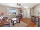 Bright living room features hardwood floors, large windows, comfortable seating, and access to the entryway at 129 N Irvington St, Aurora, CO 80018