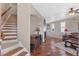 Open staircase adjacent to the living room with wood and tile details at 129 N Irvington St, Aurora, CO 80018