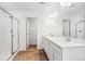 Bathroom featuring a double vanity, walk-in shower, and bright white walls at 9051 Telluride Ct, Commerce City, CO 80022