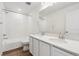 Bathroom featuring a double vanity, tub, shower, and white cabinets at 9051 Telluride Ct, Commerce City, CO 80022
