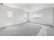 Bright bedroom featuring natural light, plush gray carpet, and bright white walls at 9051 Telluride Ct, Commerce City, CO 80022