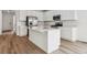 Modern kitchen boasting stainless steel appliances and a spacious quartz island at 9051 Telluride Ct, Commerce City, CO 80022