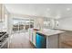 Bright open kitchen with stainless steel appliances, a quartz island, and sliding doors at 9051 Telluride Ct, Commerce City, CO 80022