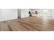 Expansive living room featuring modern laminate flooring that connects to the open-concept kitchen at 9051 Telluride Ct, Commerce City, CO 80022