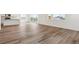 Spacious living area features laminate floors that connects to a kitchen with sliding glass doors at 9051 Telluride Ct, Commerce City, CO 80022
